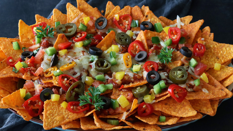 nachos with olives, jalapeños, and cheese