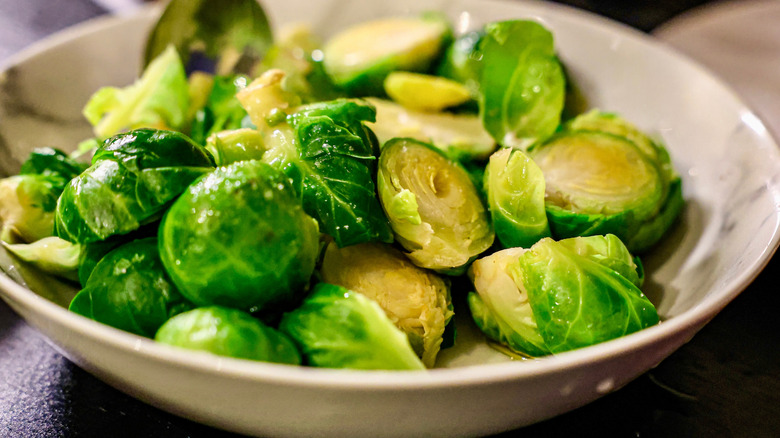 Steamed Brussels sprouts in a white bowl.