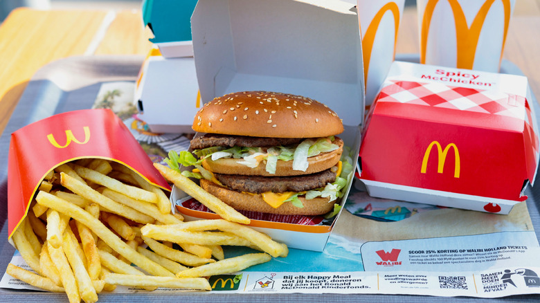 Spread of McDonalds food with Big Mac, fries, spicy McChicken, and sodas
