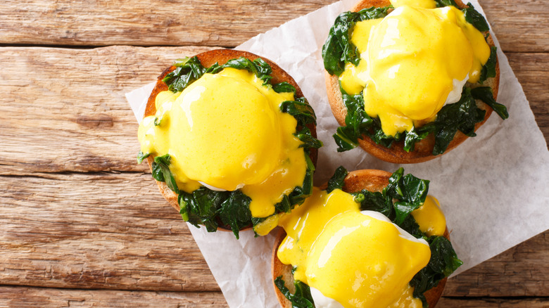 Eggs Benedict on wooden board