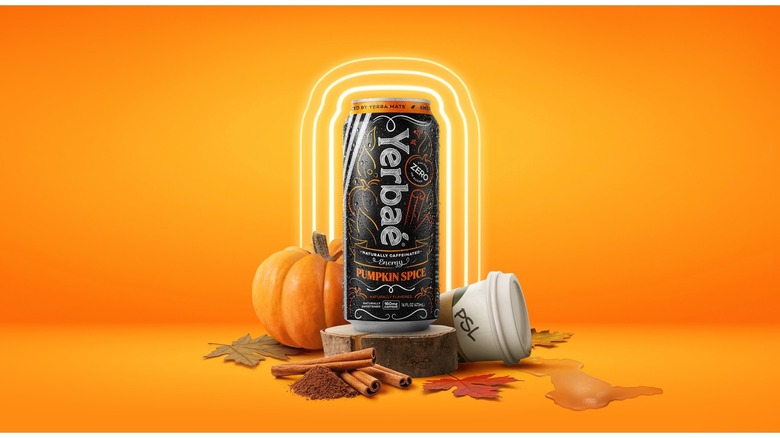 can of Yerbae pumpkin spice energy drink with PSL cup on orange background