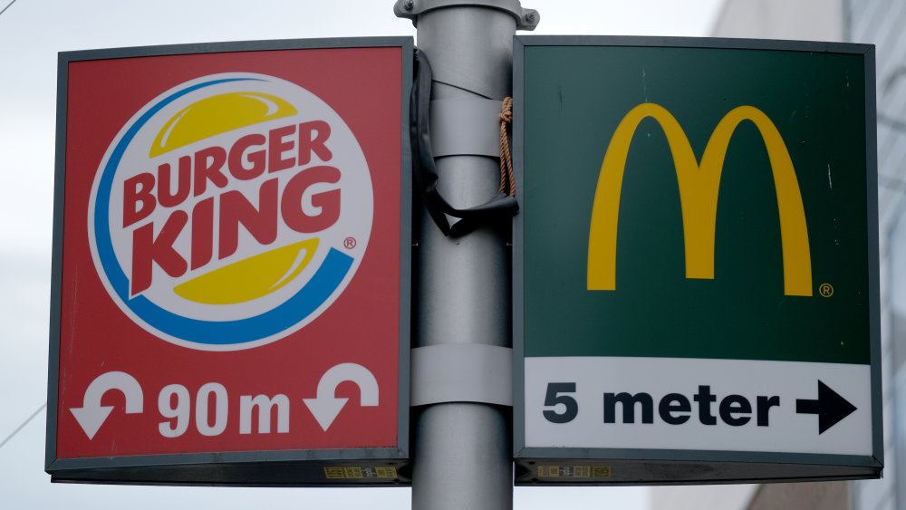 Street signs for Burger King and McDonald's