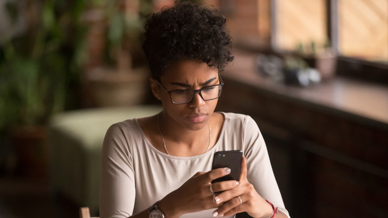 Person looking at phone with concern