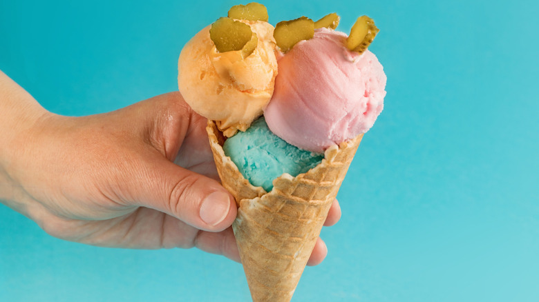 An ice cream cone topped with pickles