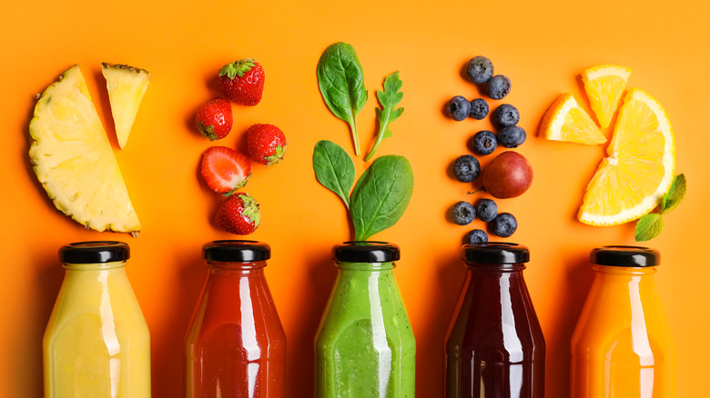 juices in bottles with fruit