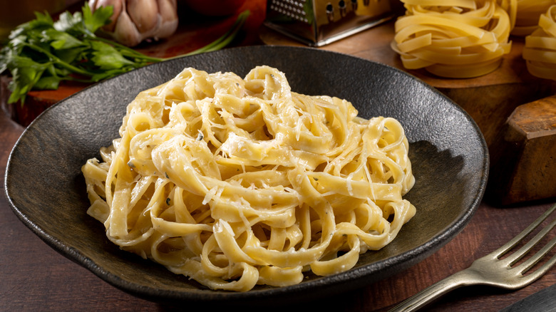 fettuccine alfredo on black plate