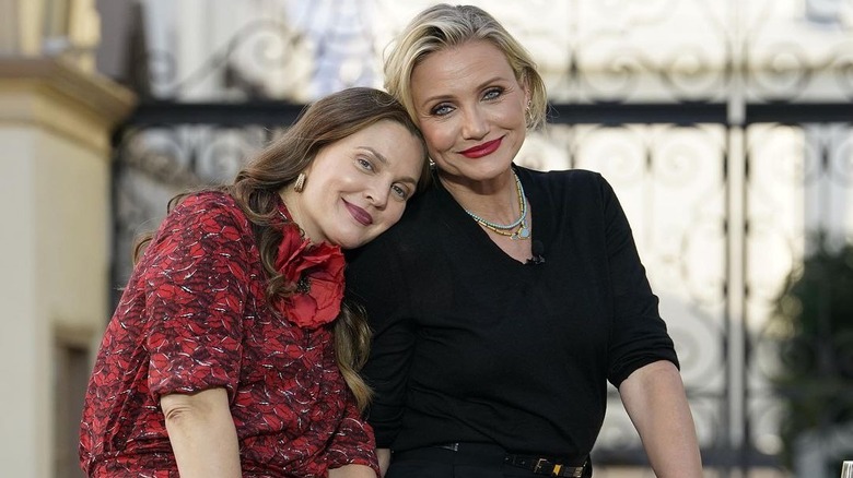 Drew Barrymore, left, and Cameron Diaz being affectionate