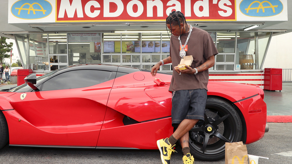 Travis Scott and his red Ferrari outside McDonald's