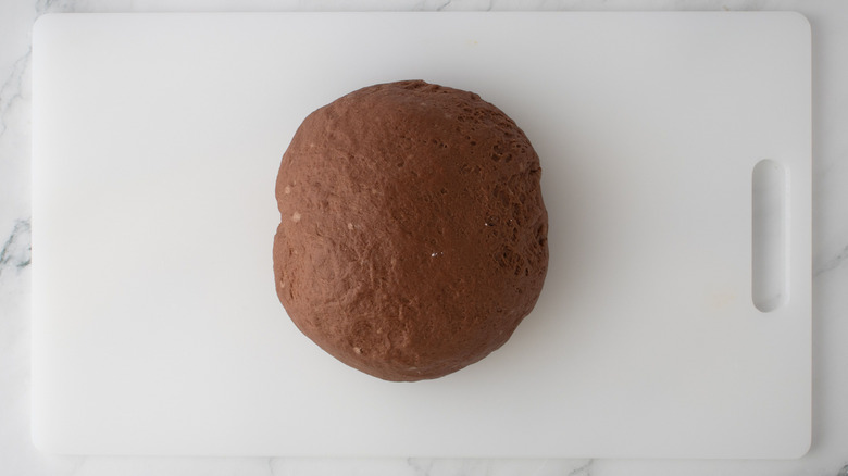 Brown bread dough ball on cutting board