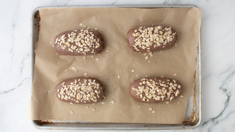 Brown bread loaves topped with oats