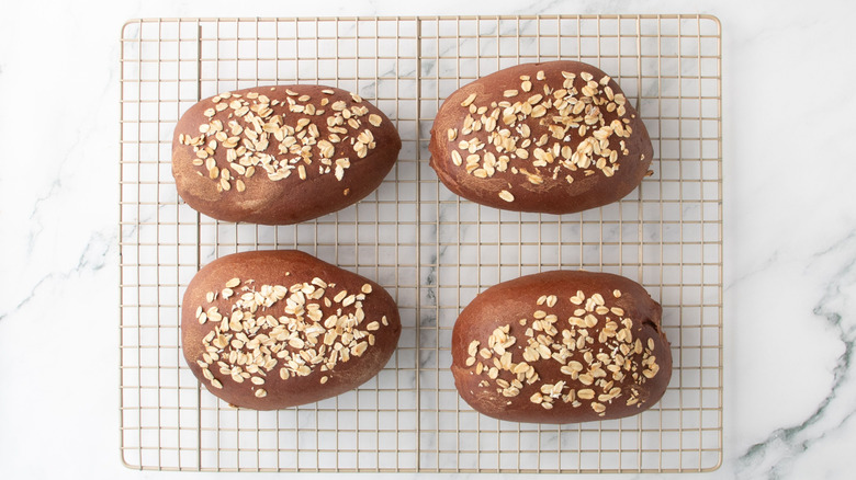 Brown bread loaves on wire rack
