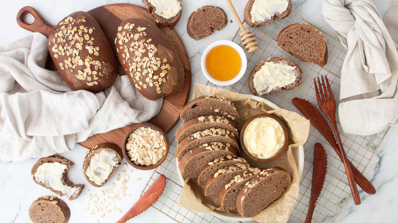Cheesecake Factory brown bread loaves next to sliced loaf with butter