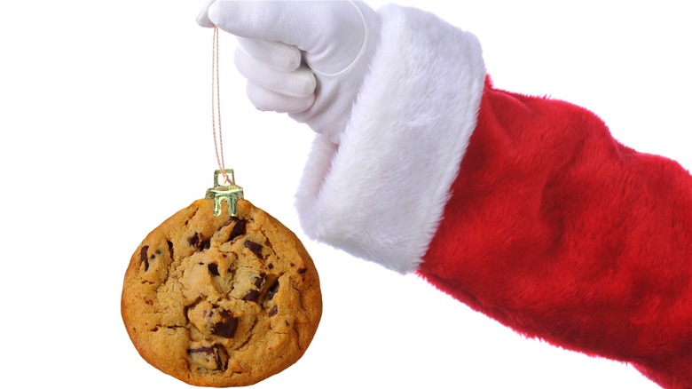 Santa holding chocolate chip cookie