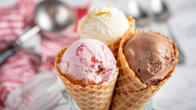Three ice cream cones: strawberry, chocolate, and vanilla