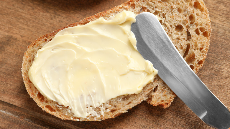 Butter spread on a slice of rustic bread.