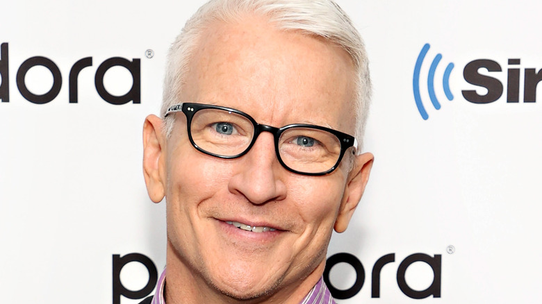 Anderson Cooper smiles with glasses