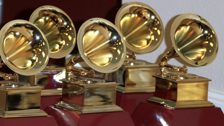 Multiple gold Grammy Awards on table