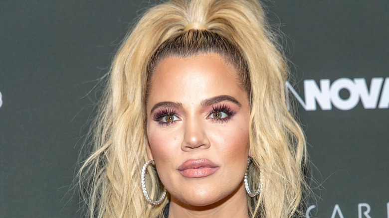 Khloé Kardashian with hair up and earrings