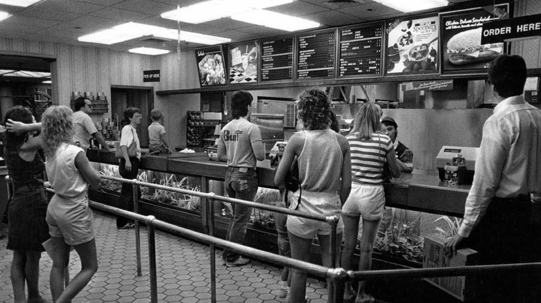 Customers waiting in line at Burger King, 1980s.