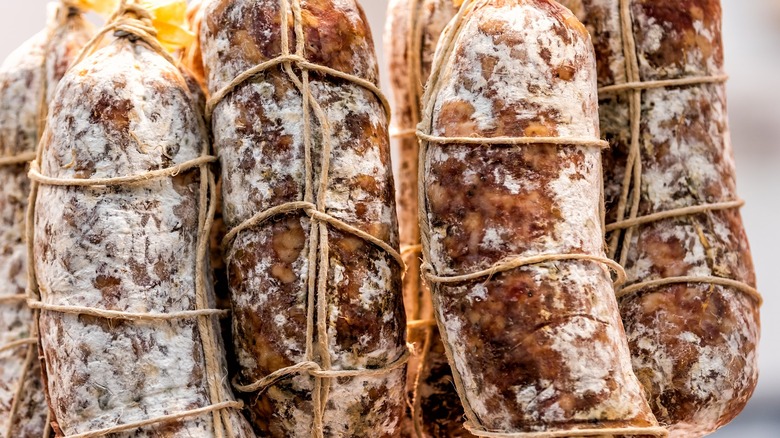 Salami hanging by ropes