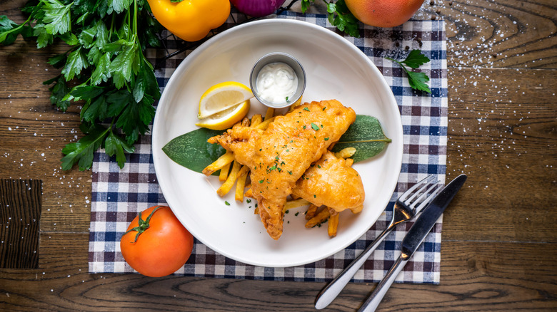 plate of fried fish with fries and lemon slices