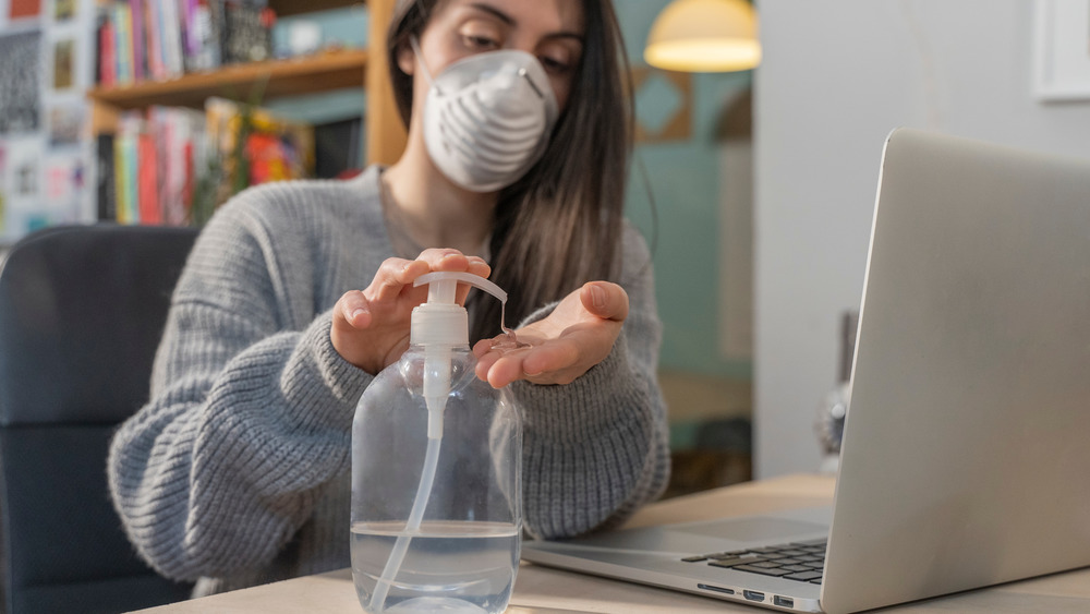 Woman using hand sanitizer 