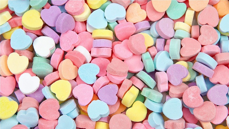 Multi-colored candy hearts scattered