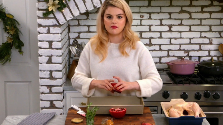 Selena Gomez with a pomegranate in hand