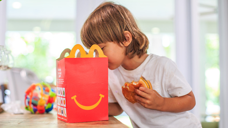A child looking inside his Happy Meal