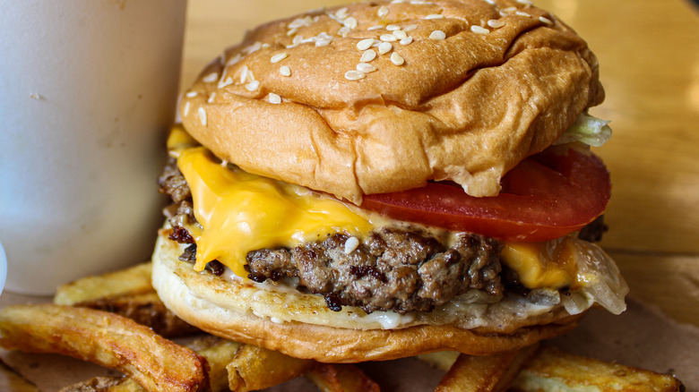 A Five Guys cheeseburger with a tomato and cheese