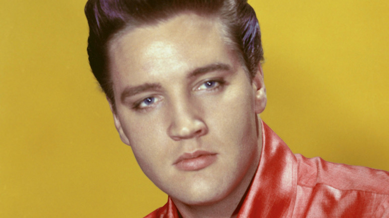 Elvis wearing a shiny red shirt