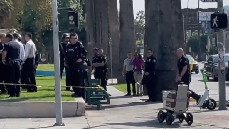 Delivery robot drives through crime scene