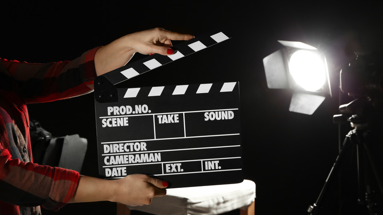 Person holding director's clapboard
