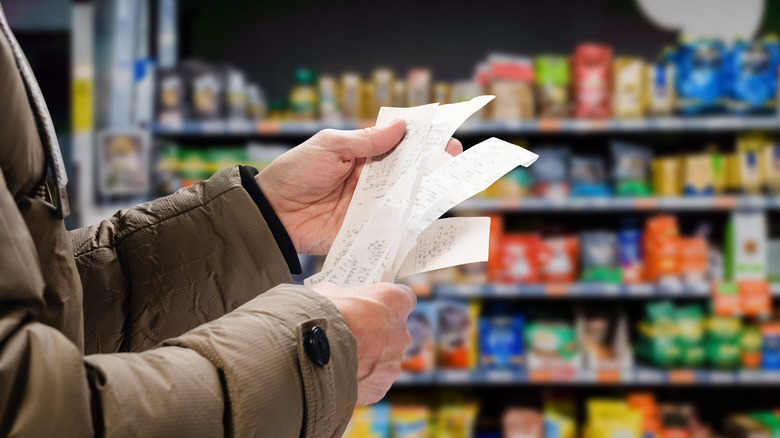 Shopper looking at grocery receipts