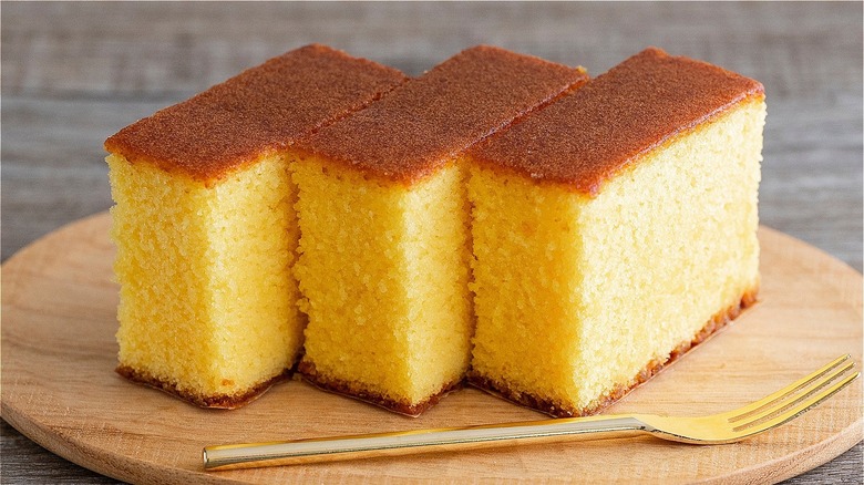 slices of angel food cake with fork on wooden board