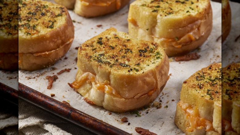 mini grilled cheese sandwiches on baking sheet