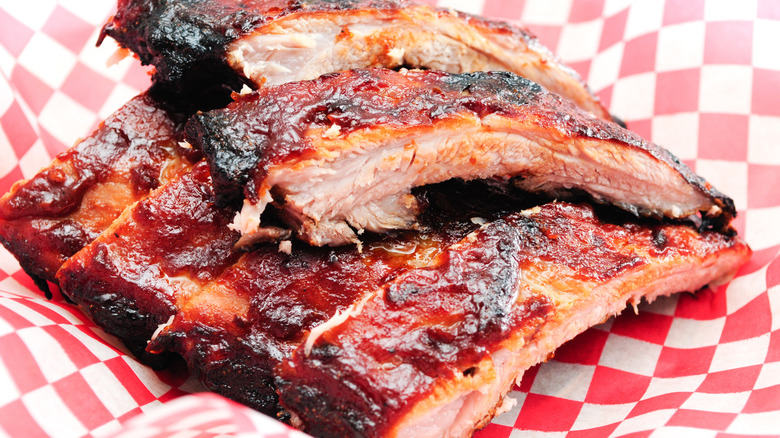Pork barbecue ribs on red and white checkered parchment paper