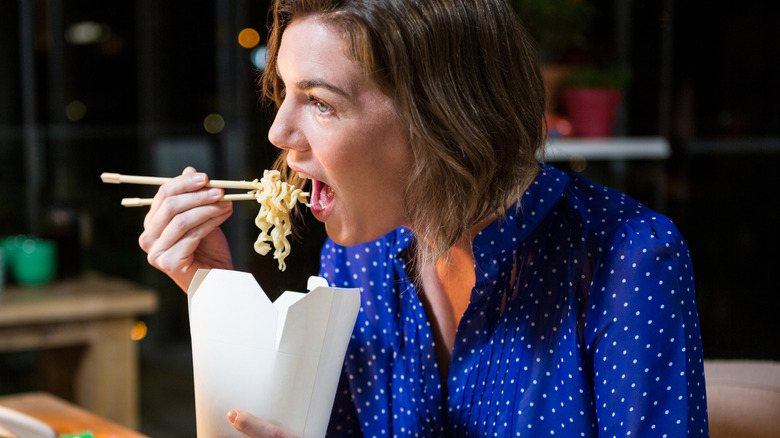 Woman eating noodles