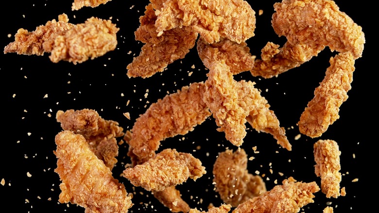 Pieces of fried chicken on a black background