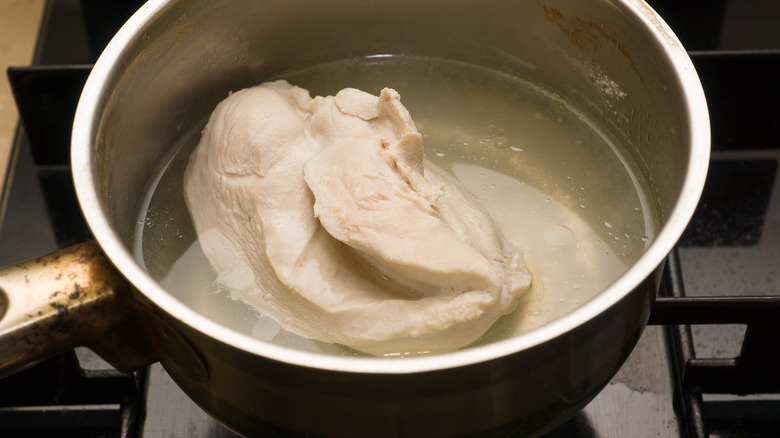 boiled chicken in pot with water