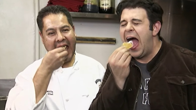 Adam Richman and chef eating testicles