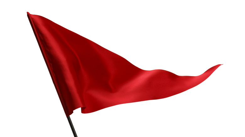 red flag flying on white background