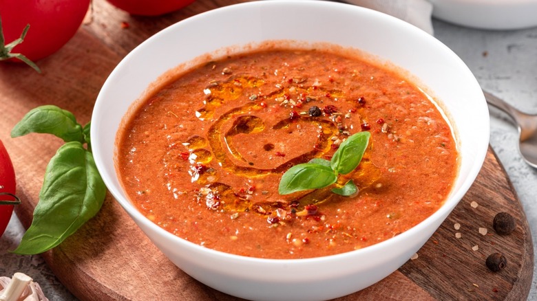 bowl of gazpacho soup with basil garnish