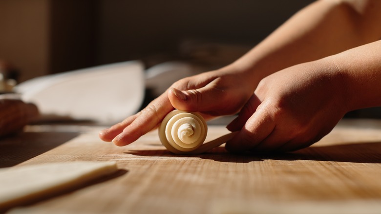 hands rolling pastry