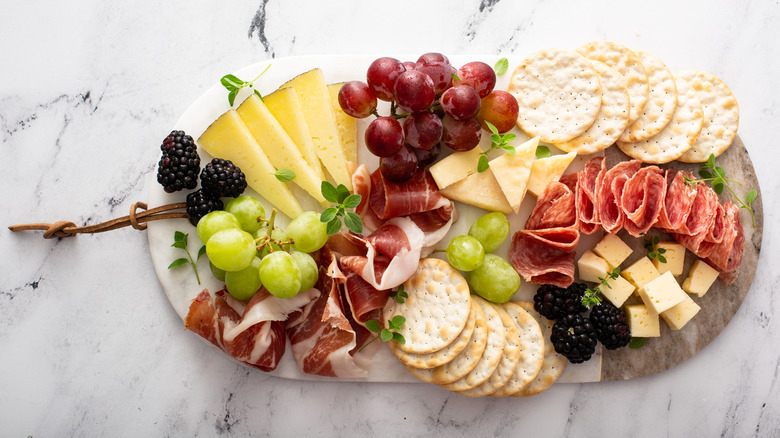 Charcuterie board with assorted cheeses, meats, and fruits