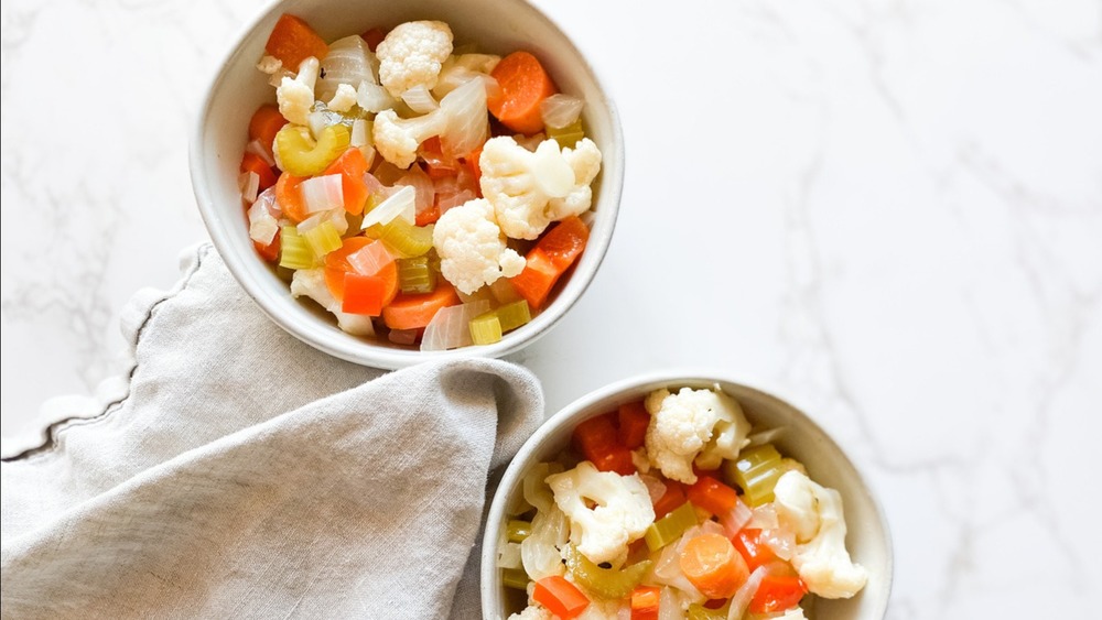 Two bowls of giardiniera with napkin