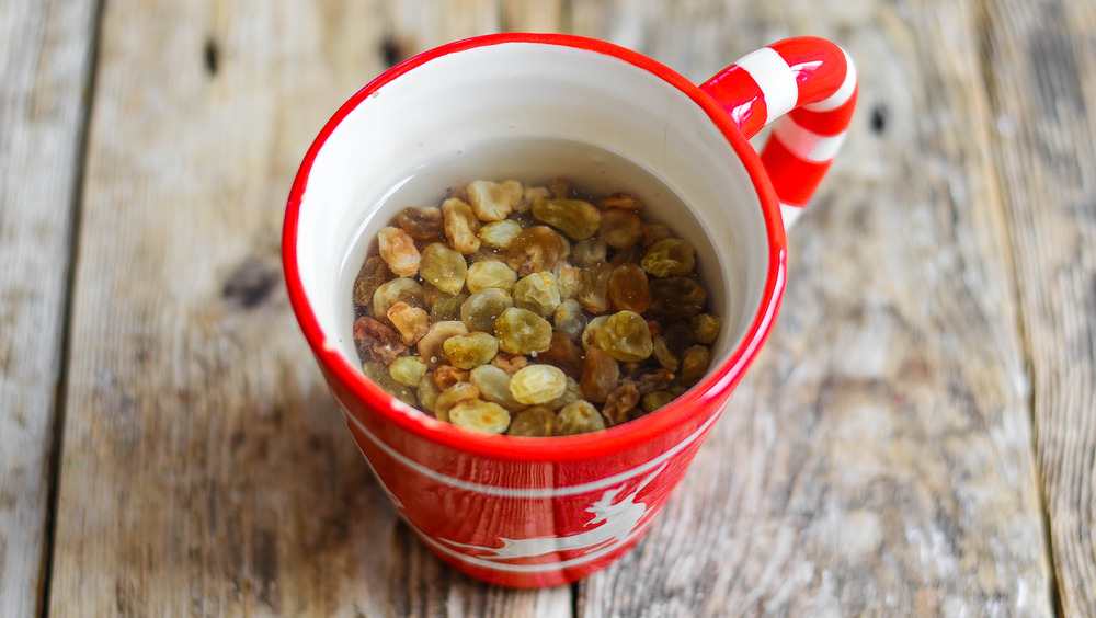 Soaking golden raisins in gin