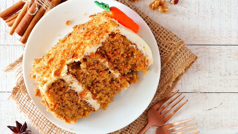 slice of carrot cake on brown cloth napkin 