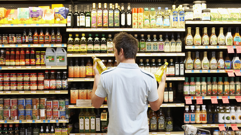 Man comparing olive oils