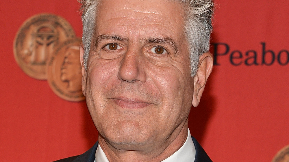 Anthony Bourdain against red background